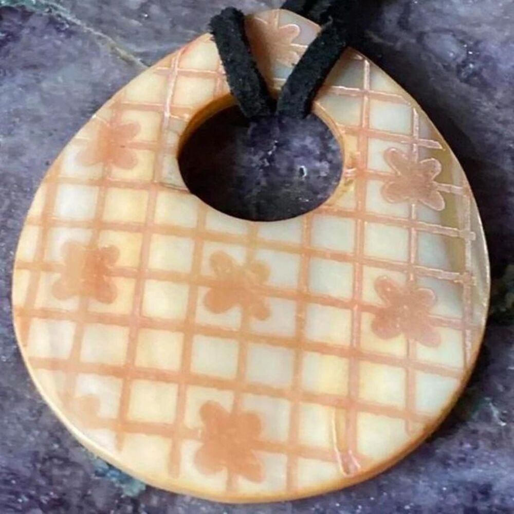 Handmade carved pendant necklace with grid pattern and floral motifs